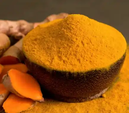 Bright yellow root powder in a small bowl